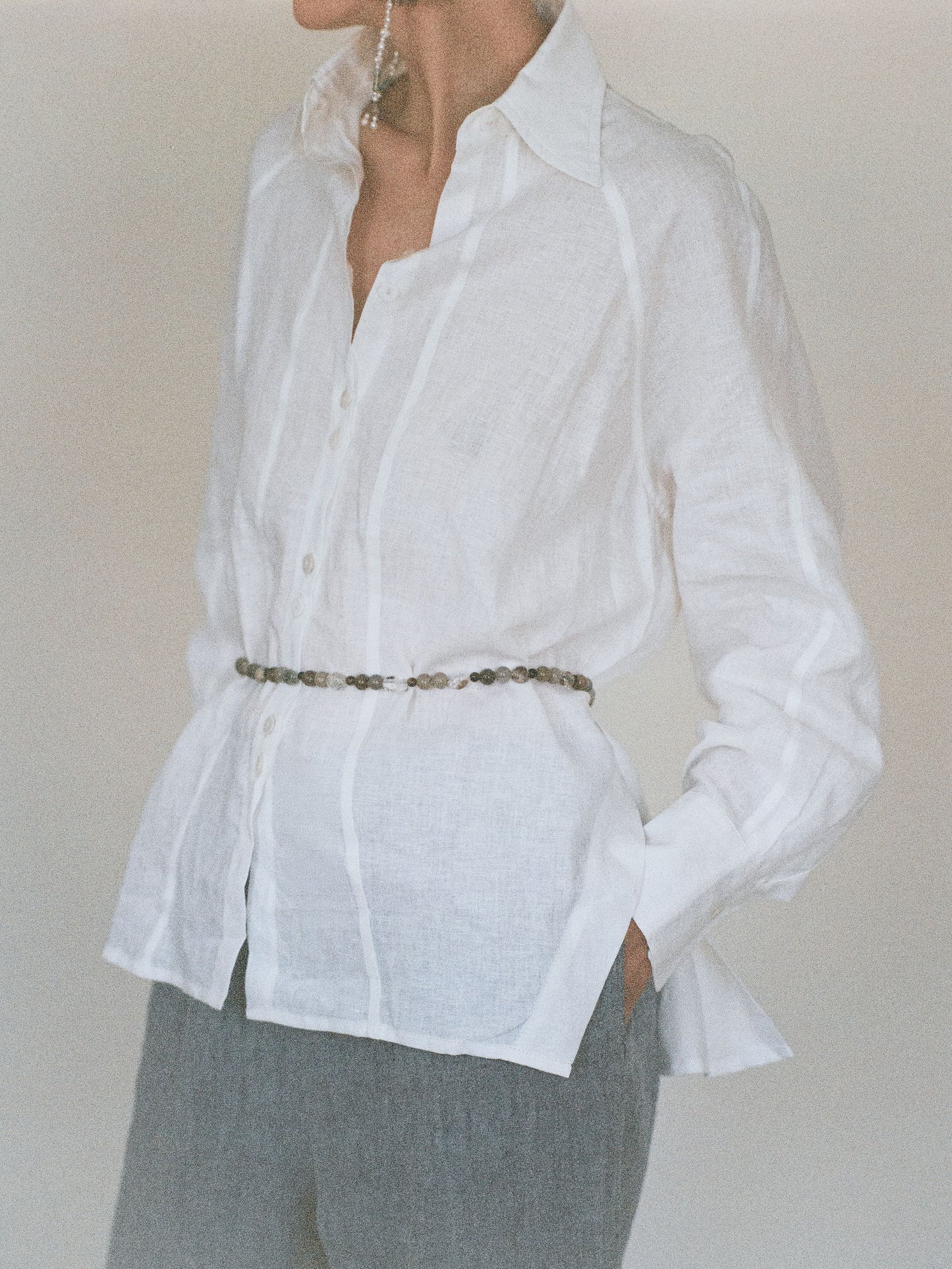 Atelier Magata Ivory white linen shirt with side slit and beaded belt and pearl earrings
