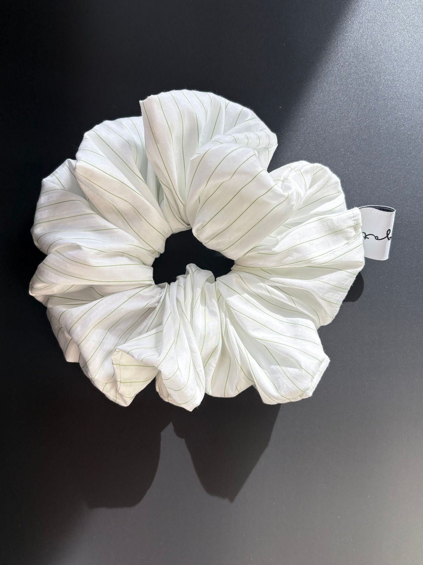 Magata Puff scrunchie white with green stripes on black background