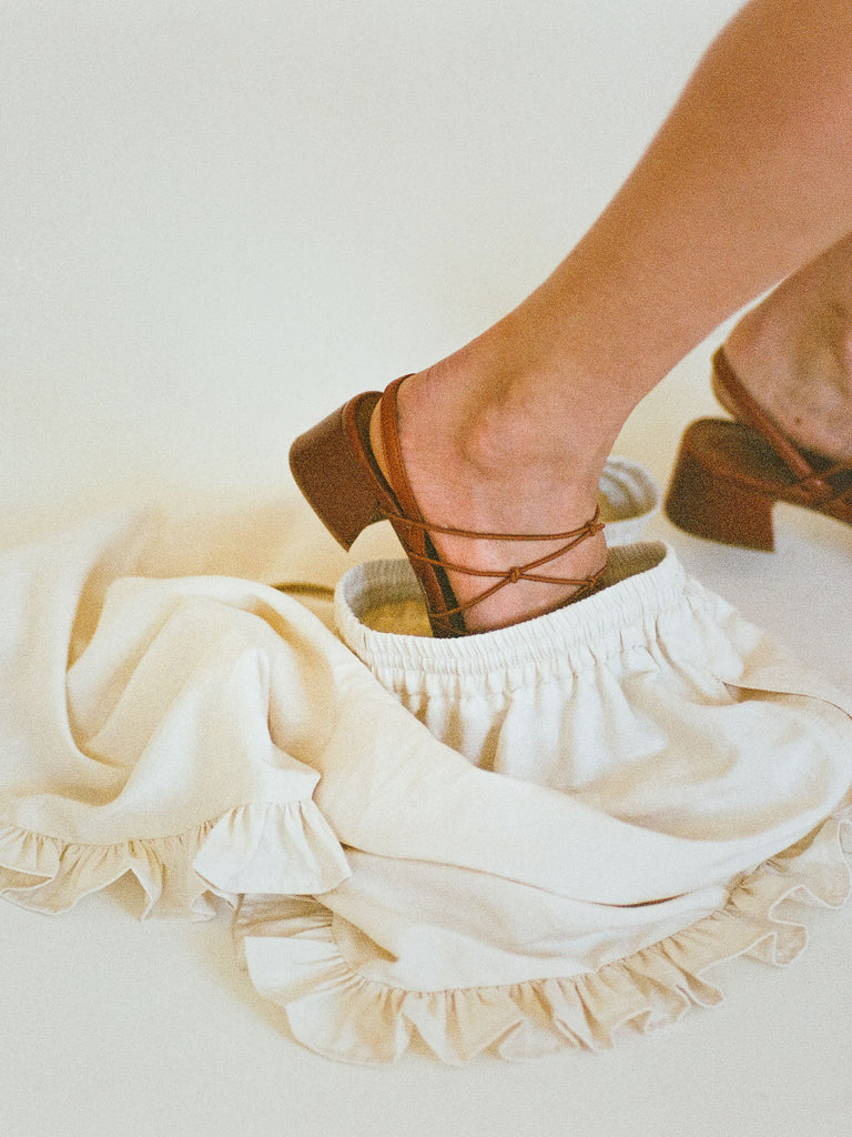 Atelier Magata Ruched creme silk linen shorts red sandals