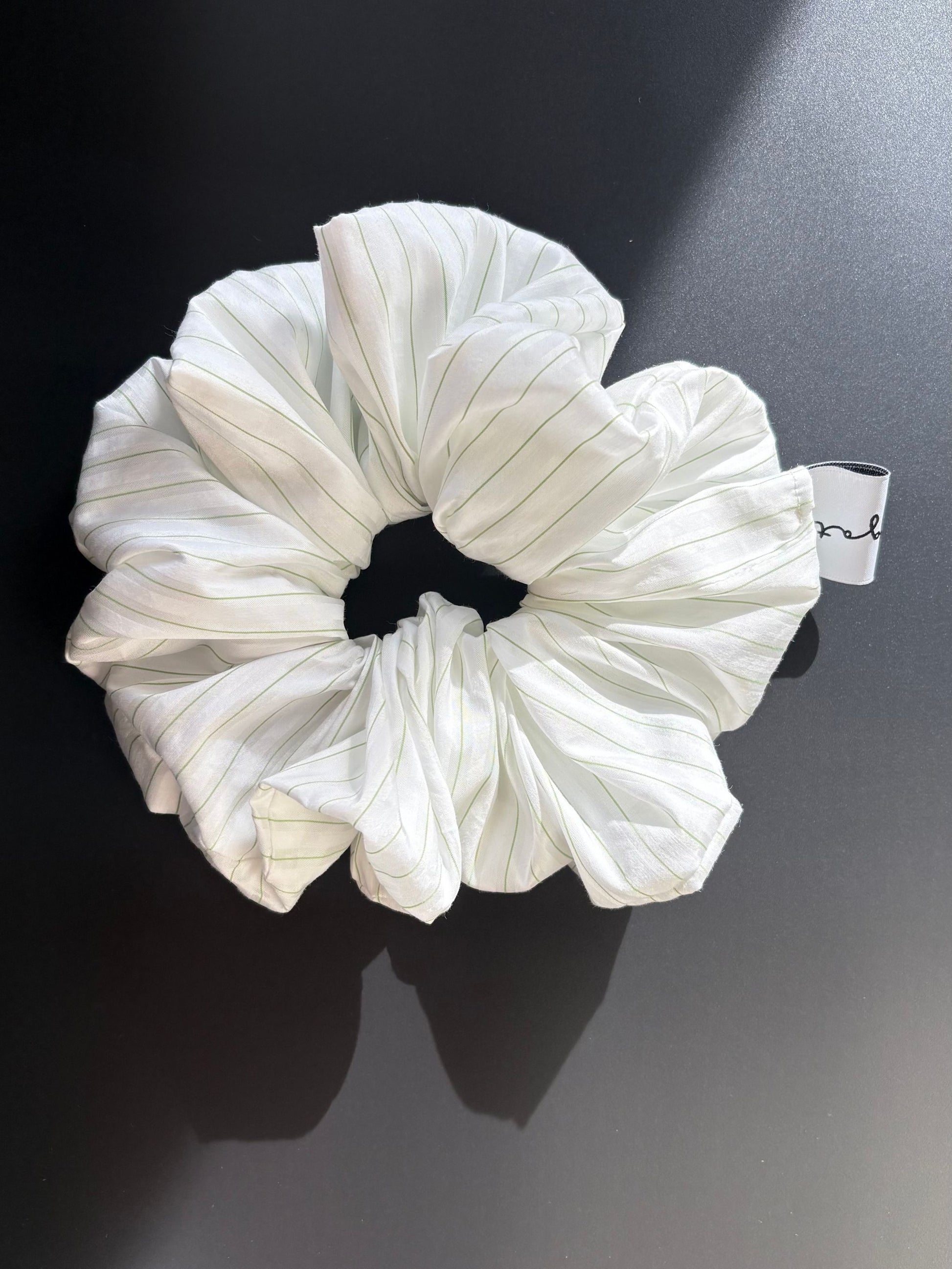 Magata Puff scrunchie white with green stripes on black background